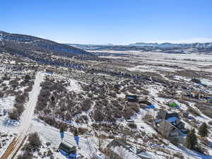 Snowy aerial view featuring a mountain view