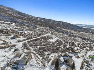 Snowy aerial view featuring a mountain view