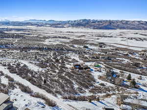 Snowy aerial view featuring a mountain view