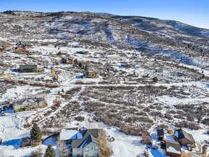 Snowy aerial view featuring a mountain view