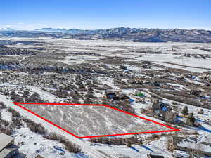 Snowy aerial view featuring a mountain view