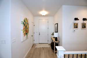 Foyer entrance with light hardwood / wood-style floors