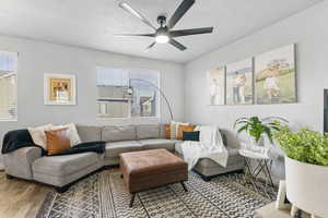 Living room featuring hardwood / wood-style flooring and ceiling fan