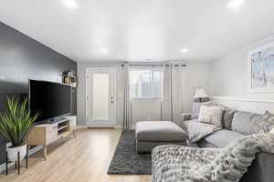 Basement featuring light wood-type flooring