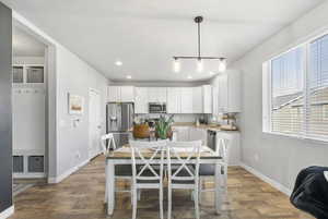 Dining space featuring light hardwood / wood-style floors, a wealth of natural light, and sink