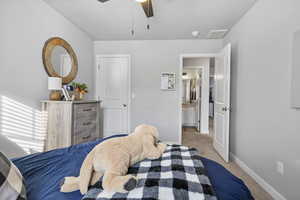 Carpeted bedroom with ceiling fan