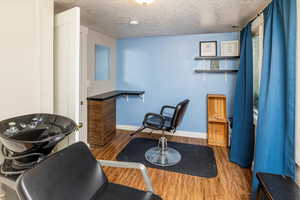 Interior space with hardwood / wood-style floors and a textured ceiling