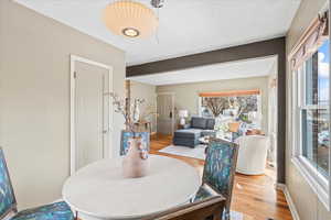 Dining area featuring a textured ceiling and light hardwood / wood-style flooring