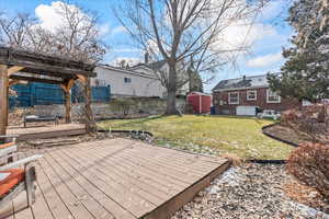 Wooden deck with a lawn and a storage shed