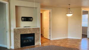 Unfurnished living room with a tile fireplace and tile patterned flooring