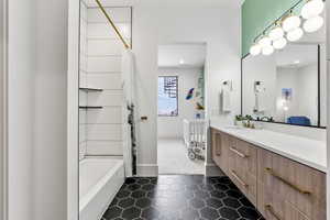 Bathroom featuring vanity and shower / tub combo