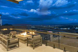 Balcony at dusk featuring a fire pit