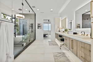 Bathroom featuring walk in shower, vanity, and ceiling fan