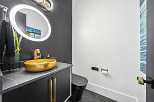 Bathroom with tile patterned floors, vanity, and toilet