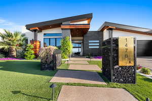 View of front of property with a front yard