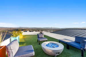 View of patio / terrace with a mountain view and a fire pit