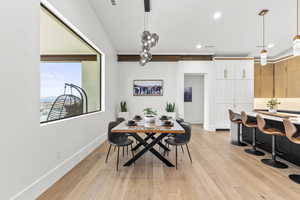 Dining space with light hardwood / wood-style flooring