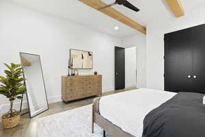 Tiled bedroom with beam ceiling and ceiling fan