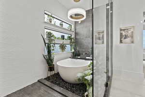 Bathroom featuring plus walk in shower and tile walls