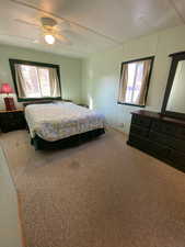 Carpeted bedroom with ceiling fan