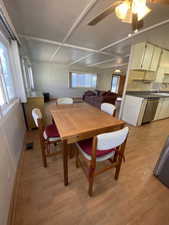 Dining room featuring ceiling fan, sink, and light wood-type flooring