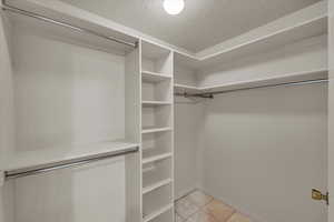 Walk in closet featuring light tile patterned floors