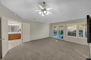 Carpeted spare room with ceiling fan