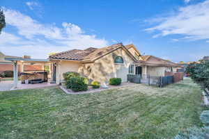 View of front of home with a hot tub and a front yard