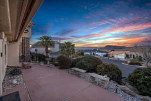 Patio terrace at dusk featuring a mountain view