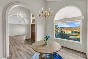 Dining area featuring light hardwood / wood-style flooring and an inviting chandelier