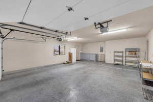 Garage with electric panel and a garage door opener