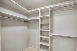 Spacious closet with light tile patterned floors