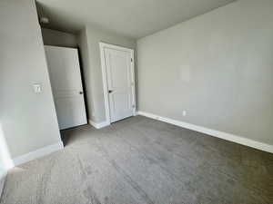 Unfurnished bedroom with carpet flooring