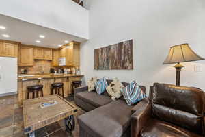 Living room featuring sink and a high ceiling