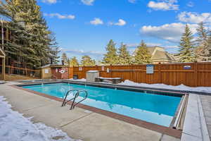 View of swimming pool with a storage shed