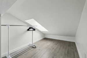 Bonus room featuring lofted ceiling with skylight