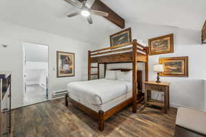 Bedroom with vaulted ceiling with beams, ceiling fan, dark hardwood / wood-style floors, and a baseboard heating unit