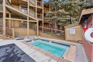 View of swimming pool featuring a community hot tub