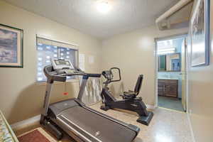 Workout area with sink and a textured ceiling