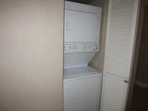 Laundry room with stacked washer and dryer