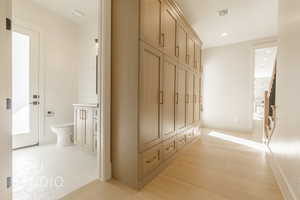 Mudroom with light hardwood / wood-style flooring