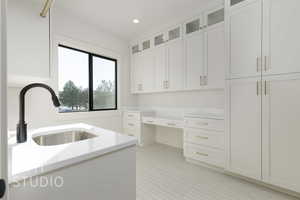 Kitchen featuring sink and white cabinets