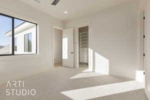 Unfurnished bedroom featuring light carpet, a closet, and ceiling fan