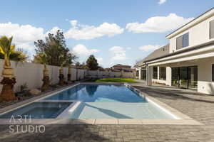 View of pool featuring a patio area and an in ground hot tub