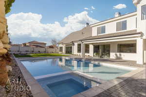 View of pool featuring a patio area and an in ground hot tub