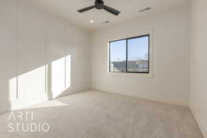 Unfurnished room featuring ceiling fan and light colored carpet