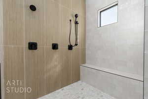 Bathroom featuring a tile shower