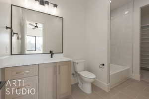 Full bathroom featuring ceiling fan, washtub / shower combination, tile patterned flooring, toilet, and vanity