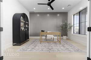 Home office featuring ceiling fan and light wood-type flooring