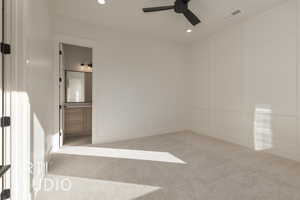 Carpeted spare room featuring ceiling fan